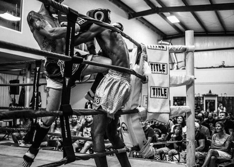 A fighter throwing a knee, full body in frame — the kind of solo round Form Fighter watches.