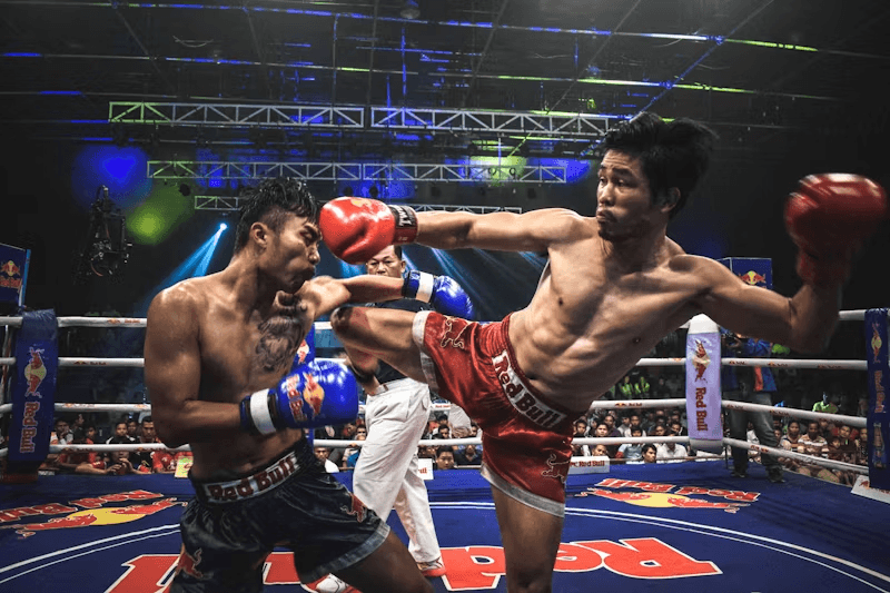 Muay Thai fighter turning a roundhouse over into his opponent's high guard — the hip rotation Form Fighter scores.